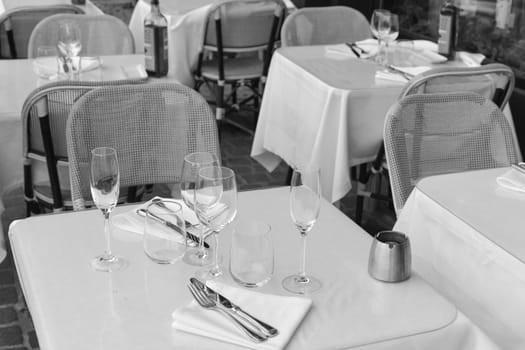 Set table in a street cafe outdoors with wine glasses