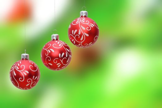 three christmas baubles hanging from the tree with space for text, postcard