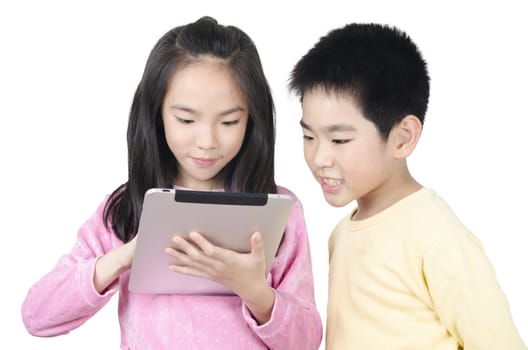 two happy children using touch pad computer and isolated on white