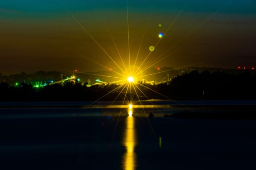 Great radiant sunset over the calm lake