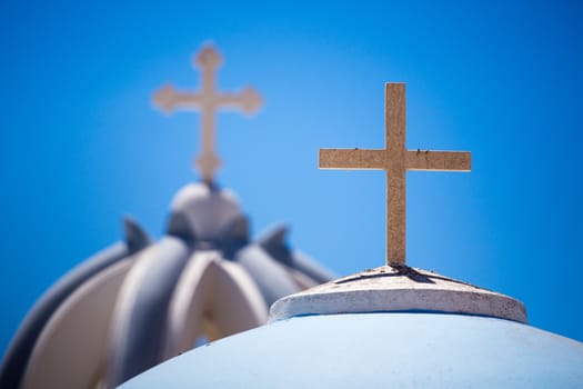 Close up from Orthodox Crosses on the beautiful Blue and white rooftops of a orthodox church,  There are many small churches all over Santorini. and some larger churches in each of the major villages ..Greece, 2013.