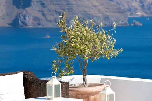 Little Lemon tree, a table, a lantern and a confortable chair in a hotel on the caldera in Santorini, Greece 2013.