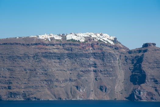 Panoramic view of the  Caldera in Santorini, Fira is visible with its traditional Greek houses in the background. Blue sky and blue aegean see, Greece 2013.