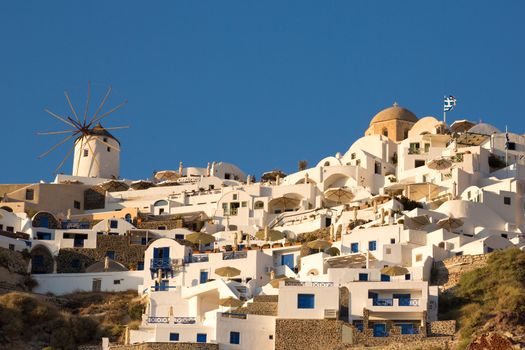 Windmill and different hotels at Oia, the best location on the island of Santotini to see the sunset, Greece 2013.