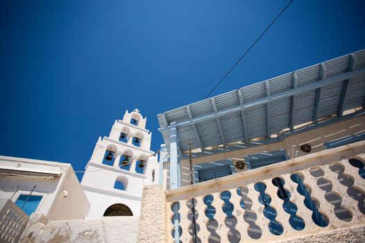 The beautiful bell tower of the church in Red Beach, the most famous beach of Santorini