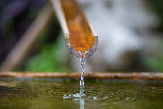 Traditional bamboo fountain with water in a temple in Hangzhou, China