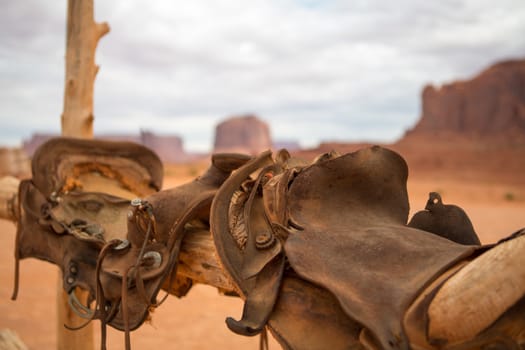 Saddle and red rocks in monument valley. Horizontal color photo