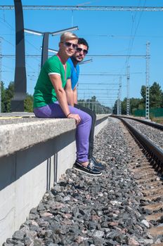 Shot of two young men sitting on platform