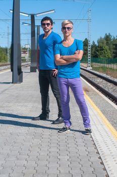 Shot of two young men standing on platform