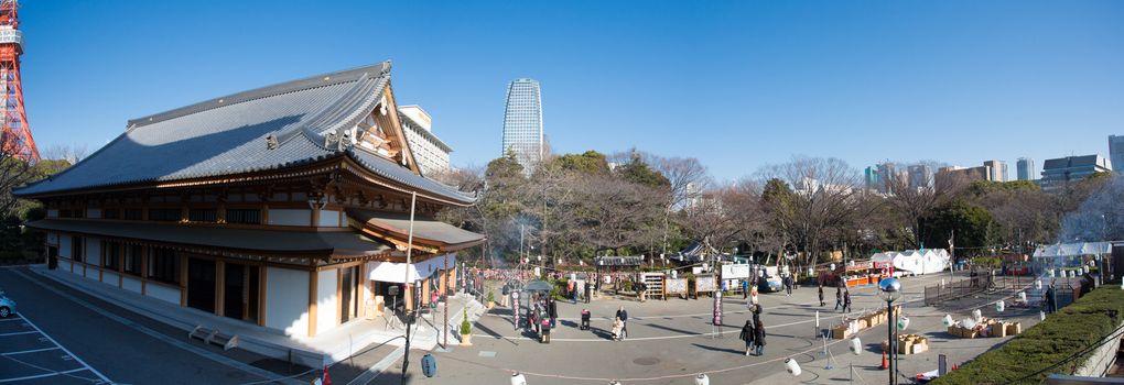 TOKYO, JAPAN, JANUARY 1: Zojoji temple, worshipers and Tokyo tower in Minato-ku, Tokyo, Japan 2013.