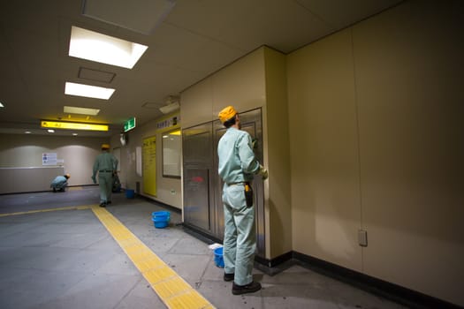 TOKYO, JAPAN - JANUARY 6: Unidentified group of cleaners cleaning the subway of Tokyo, walls, floor and details.