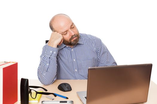 A sleeping man with a beard in front of his PC isolated on white background