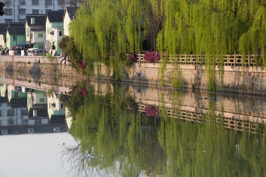 Residential buildings, trees and Small canal in Qibao, Shanghai, China 2013.