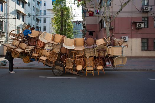 Old and cheap chairs packed on an trailer in the street of Shanghai, China