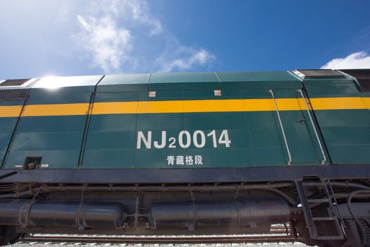 View of the locomotive of the Shanghai - Lhasa train stopped in a train station in Tibet. China 2013.