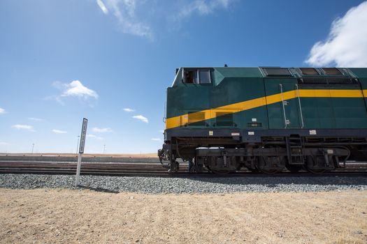 View of the locomotive of the Shanghai - Lhasa train stopped in a train station in Tibet. China 2013.