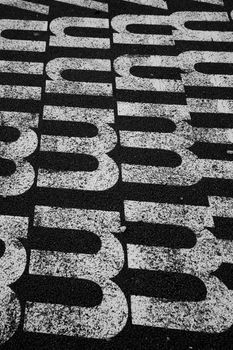 White letter m against a black toad in Lisboa, Portugal.