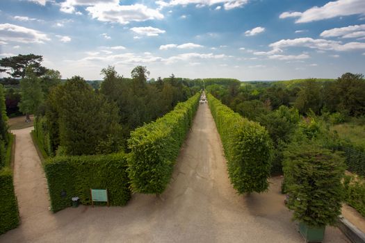 Blue sky and the green lanes of Versailles Palace in Paris. Perfect walk on a sunny sunday in France. Versailles 2011.