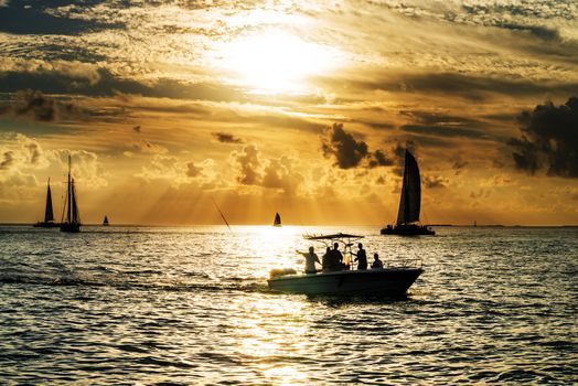 Sailboat and disherman in the sea at sunset, Key west bay, Floride, USA 