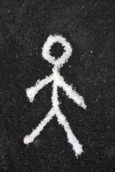 Black blackground and white man standing pictogramme painted  on the street