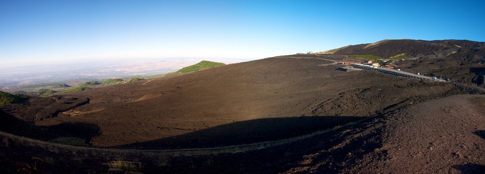 Panoramic view of the Etna early in the morning with a blue sky