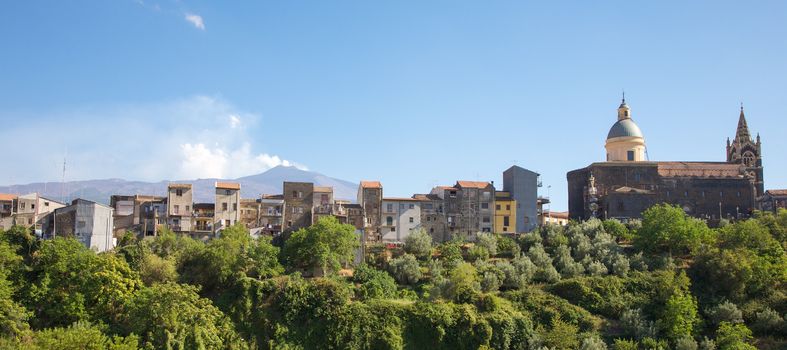 Houses in the city of Centuripe in Sicily, on background the volcano Etna partly in activity. Italy 2011.