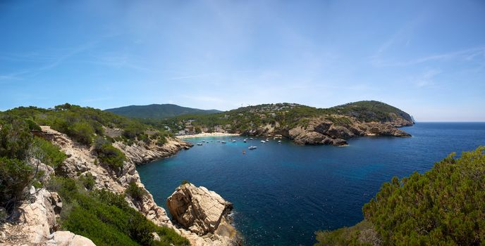 Ibiza mediterranean coast line with sun and blue sky