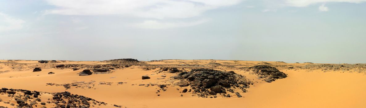 Panoramic view. Sandy and deserted landscape in the Libyan desert.