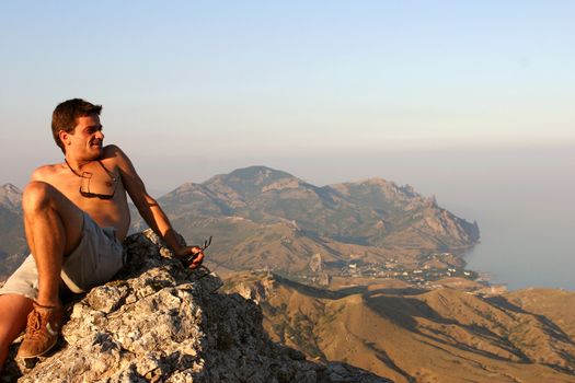 Man looking at the Black Sea Coastline at Sudak town in Crimea, Ukraine