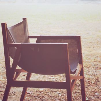 Modern wood chair in the garden with retro filter effect