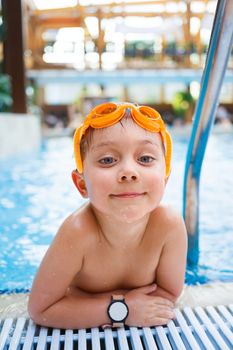 Activities on the pool. Cute boy in swimming pool