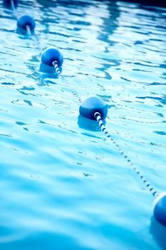 Blue water buoys in pool, shallow depth of field