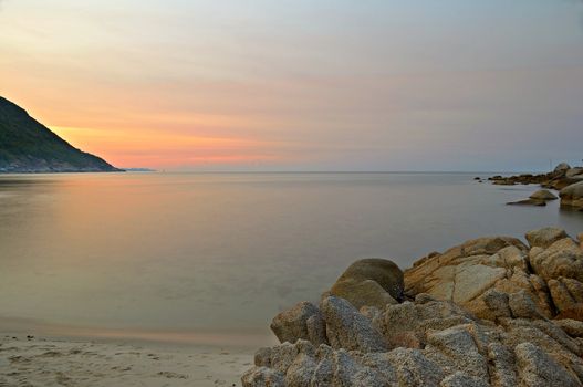 Vibrant colored sunset and blurred motion seascape at Ao Haad Khaud, Koh Phangan, Southern Thailand.