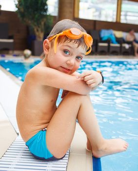 Activities on the pool. Cute boy in swimming pool