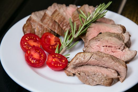 Juicy steak on the plate with some tomatoes