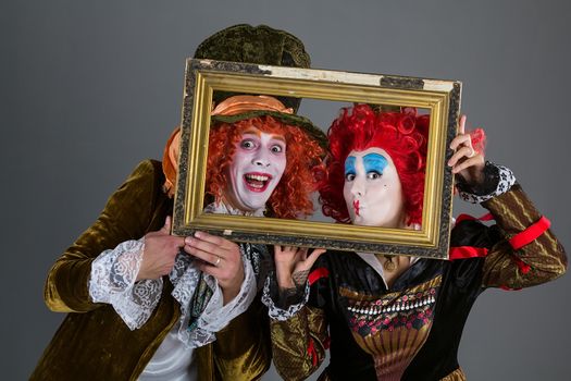 Characters from wonderland crazy hatter and red queen with a frame