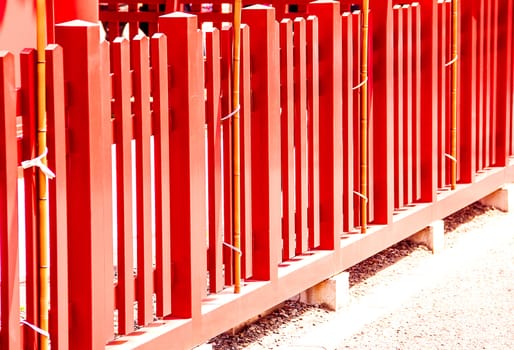 Red wooden fence located on the ground.