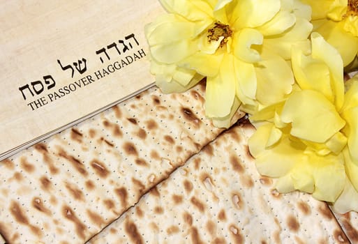 spring holiday of Passover and its attributes, with matzo and Haggadah in Hebrew - Happy Passover