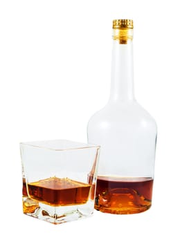 Almost empty bottle and glass of whiskey isolated on white background with clipping path