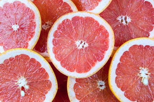 Background of heap fresh red grapefruit slices