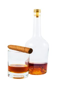 Almost empty bottle and glass of whiskey with cigar isolated on white background with clipping path