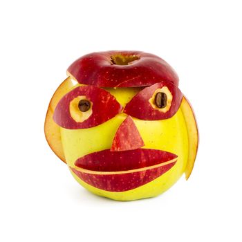 Creative muzzle from two apples of yellow and red color