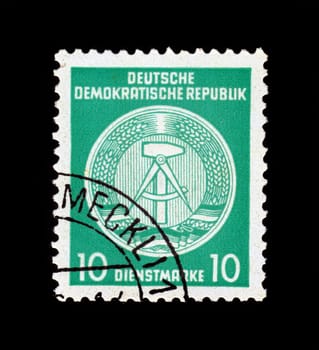 GDR - CIRCA 1952: Stamp printed in German Democratic Republic - East Germany shows national coat of arms, caliper compasses and hammer, union of intellectuals and workers, green background, circa 1952