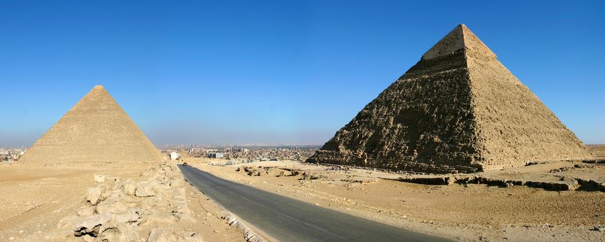 Panorama view of Giza pyramids with a blue sky