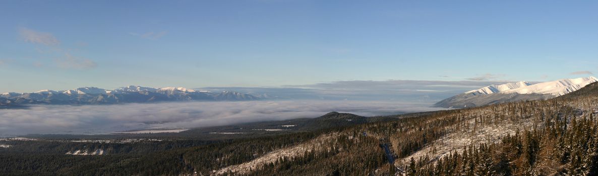 Panoramic view of The Tatra Mountains early in the morning. A mountain range that form a natural border between Slovakia and Poland. They are the highest mountain range in the Carpathian Mountains.