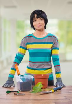 female at table with tools for repot plowers