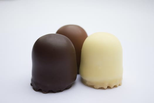 Chocolate covered dark brown, light brown and white marshmallows.