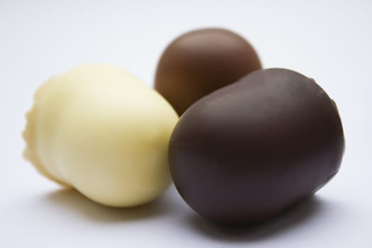 Chocolate covered dark brown, light brown and white marshmallows.
