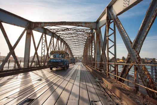 Public bus crossing the Faidherbe Bridge in Saint Louis. Faidherbe Bridge is a road bridge over the Sénégal River which links the island of the city of Saint-Louis in Senegal to the African mainland. Lenght is 507 meters and it has been replaced in 2011.