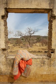 Sheeting hanging at the window in the middle of the bush in Mali